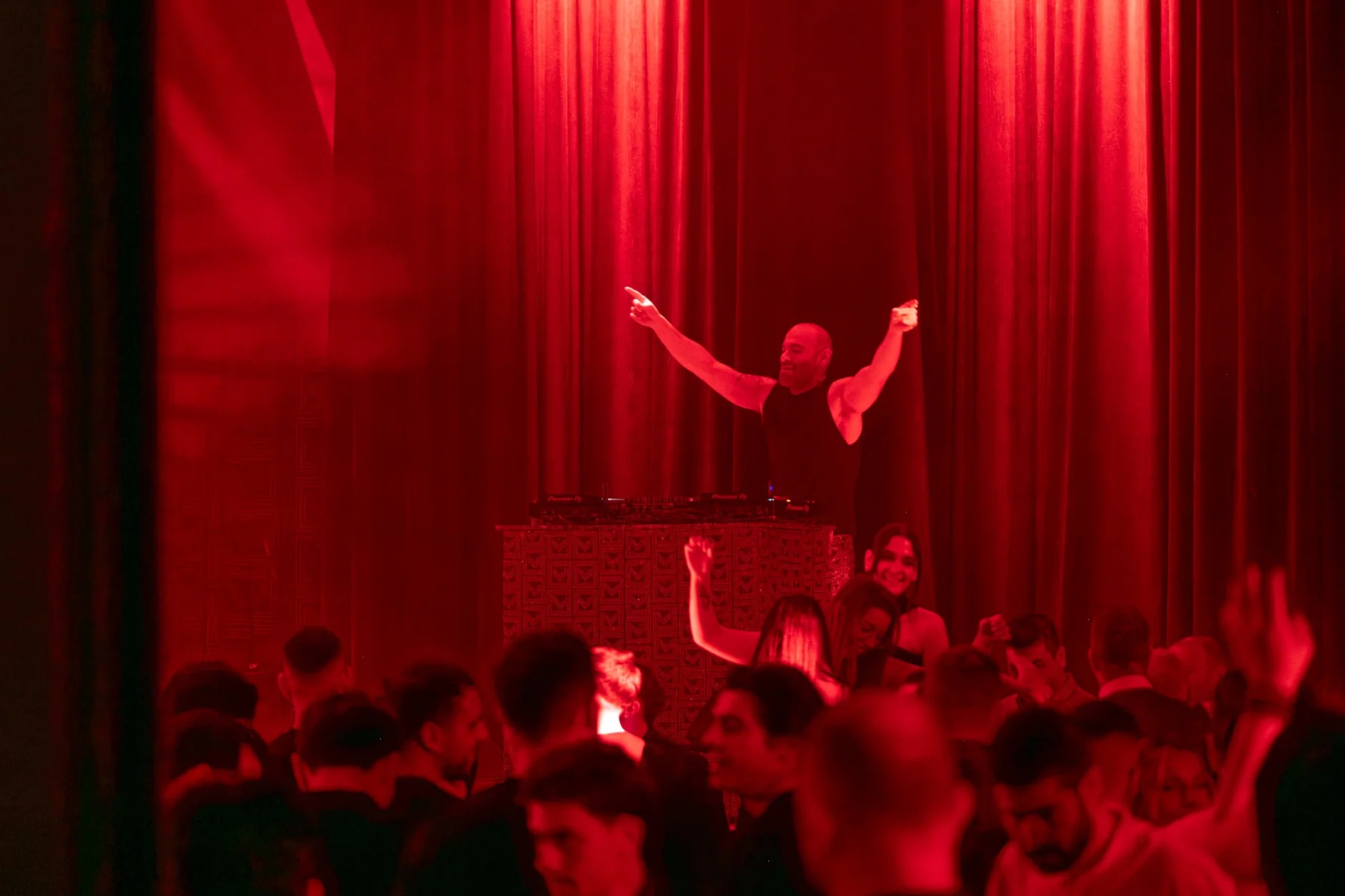 Nikkolas Dashy performing under red stage lights